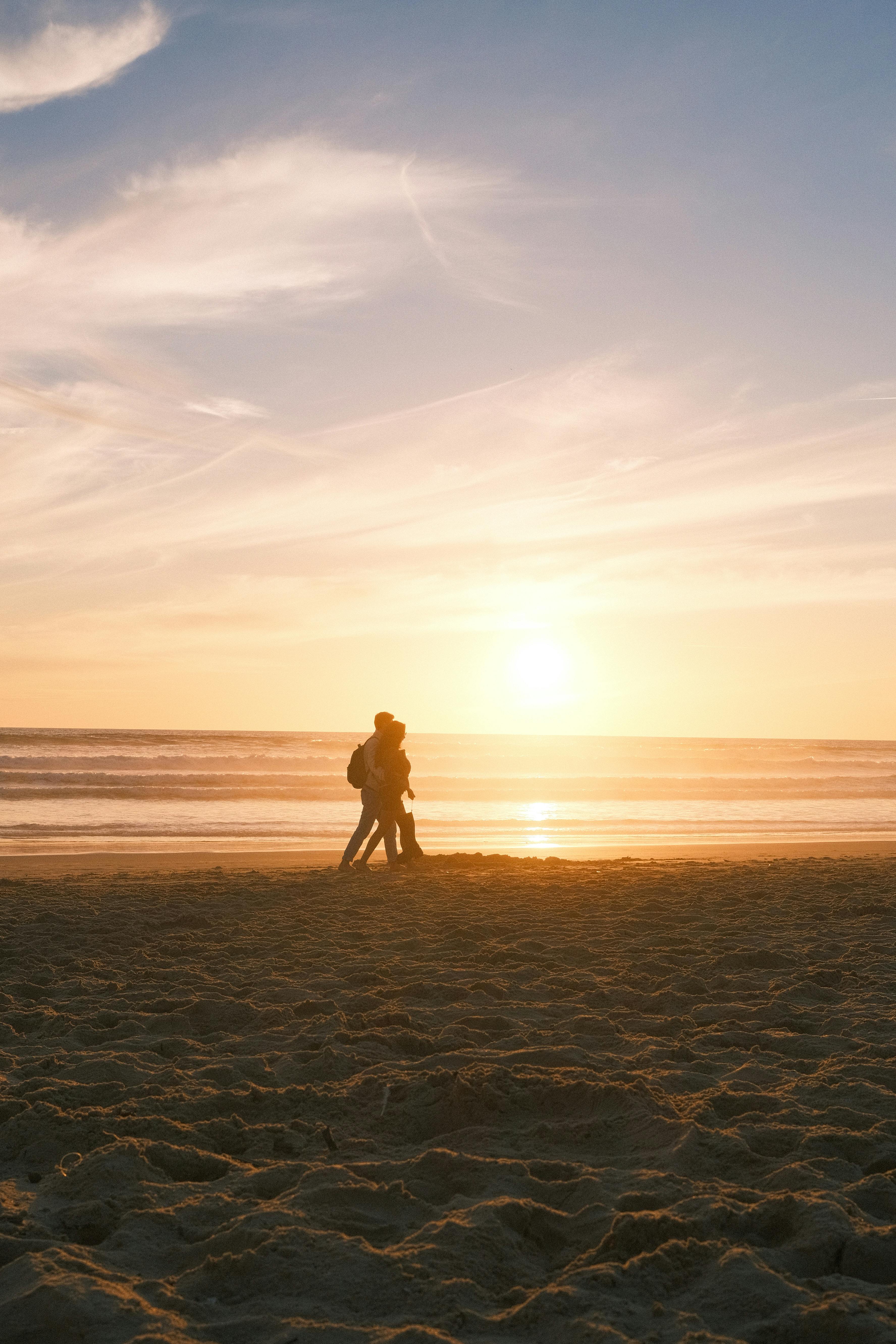people silhouettes on beach
