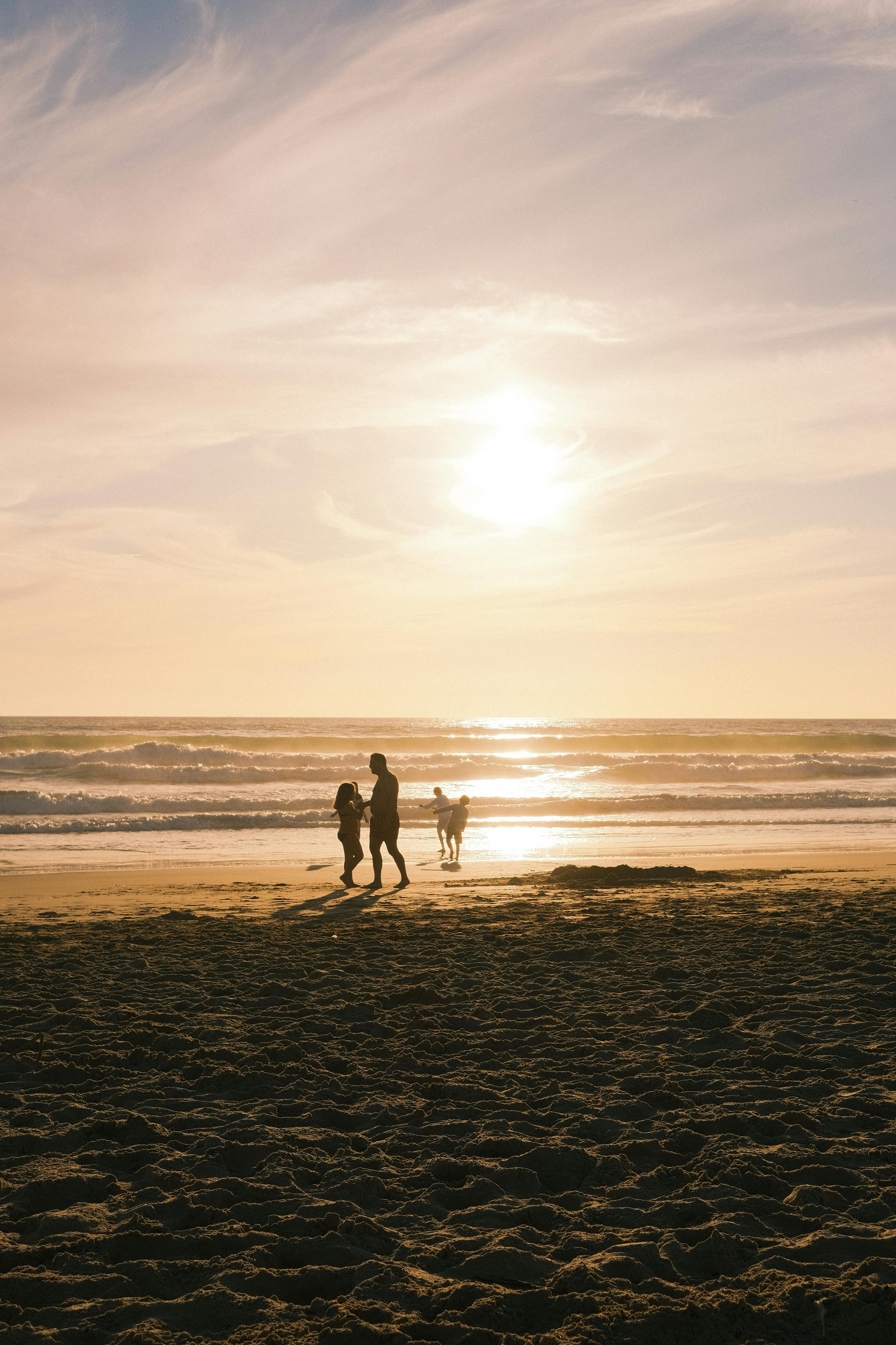people silhouettes on beach