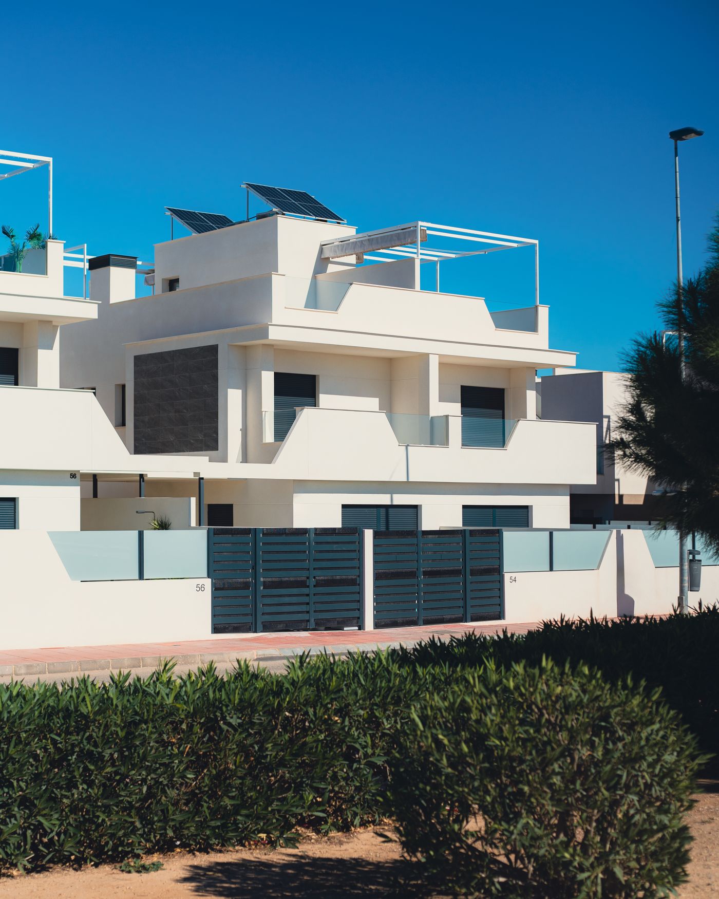 JVC villa cleaning service — white modern villas under blue sky