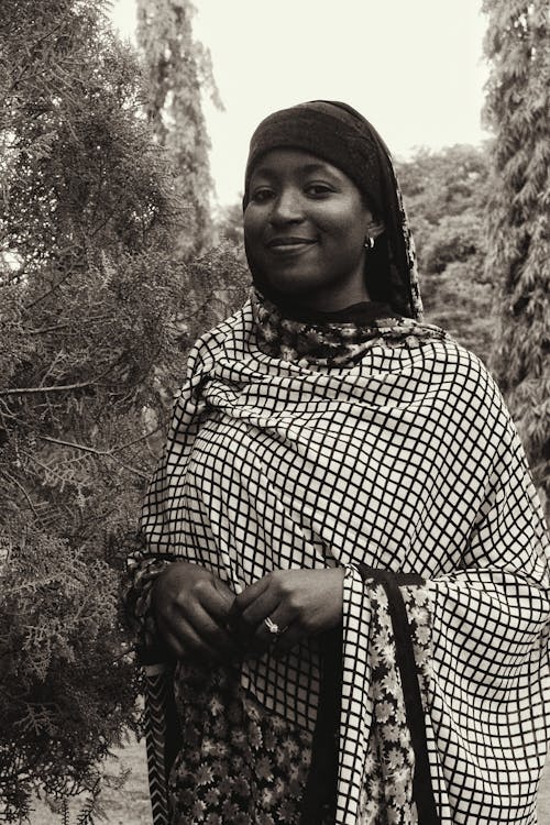 A black and white photo of a woman in a head scarf