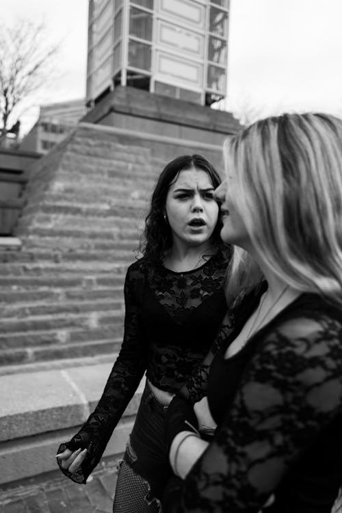 Two women standing on the steps of a building