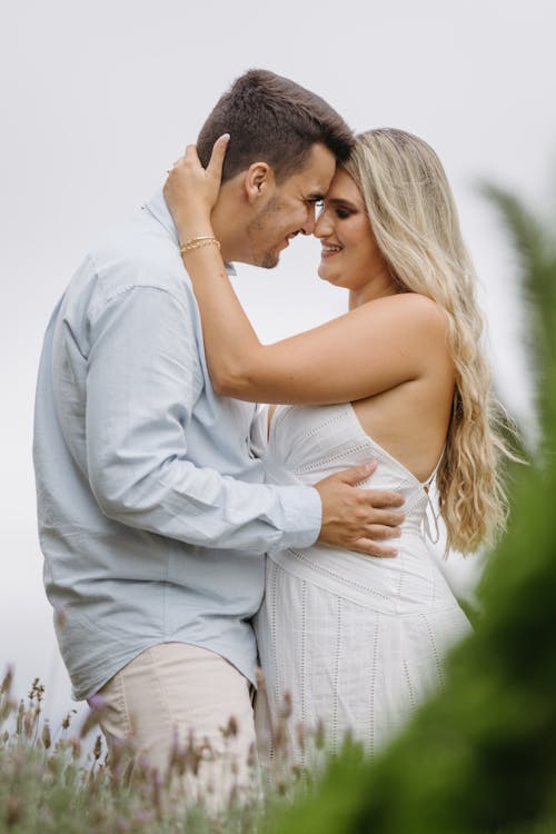 A couple embracing in the middle of a field