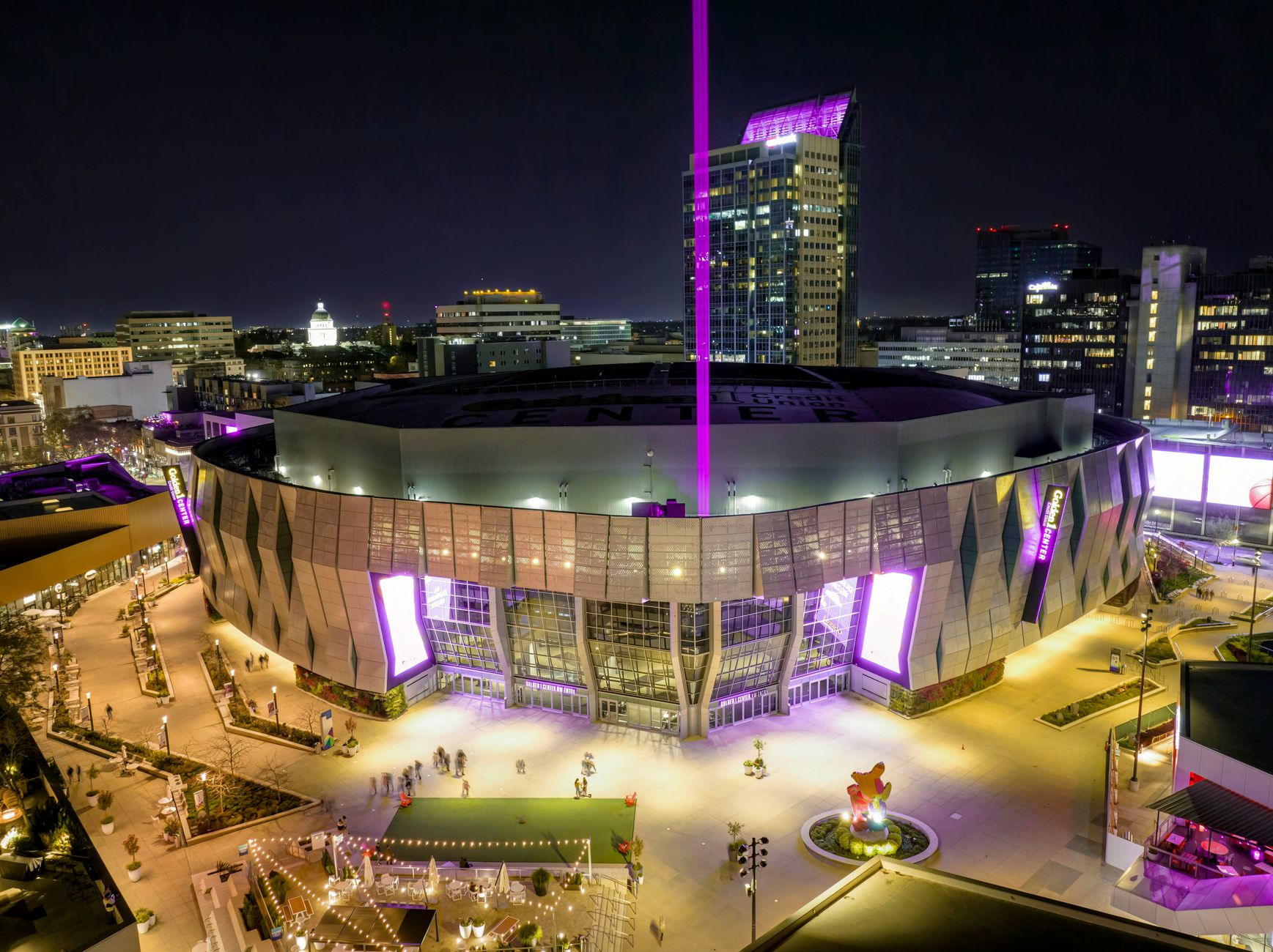 Kansas City stadium illuminated at night, football supporters gathering outside before a FIFA World Cup 2026 match