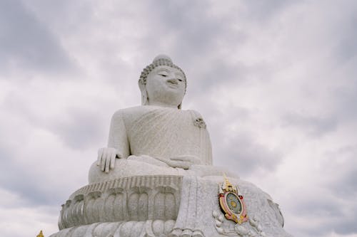 A large buddha statue sitting on top of a hill
