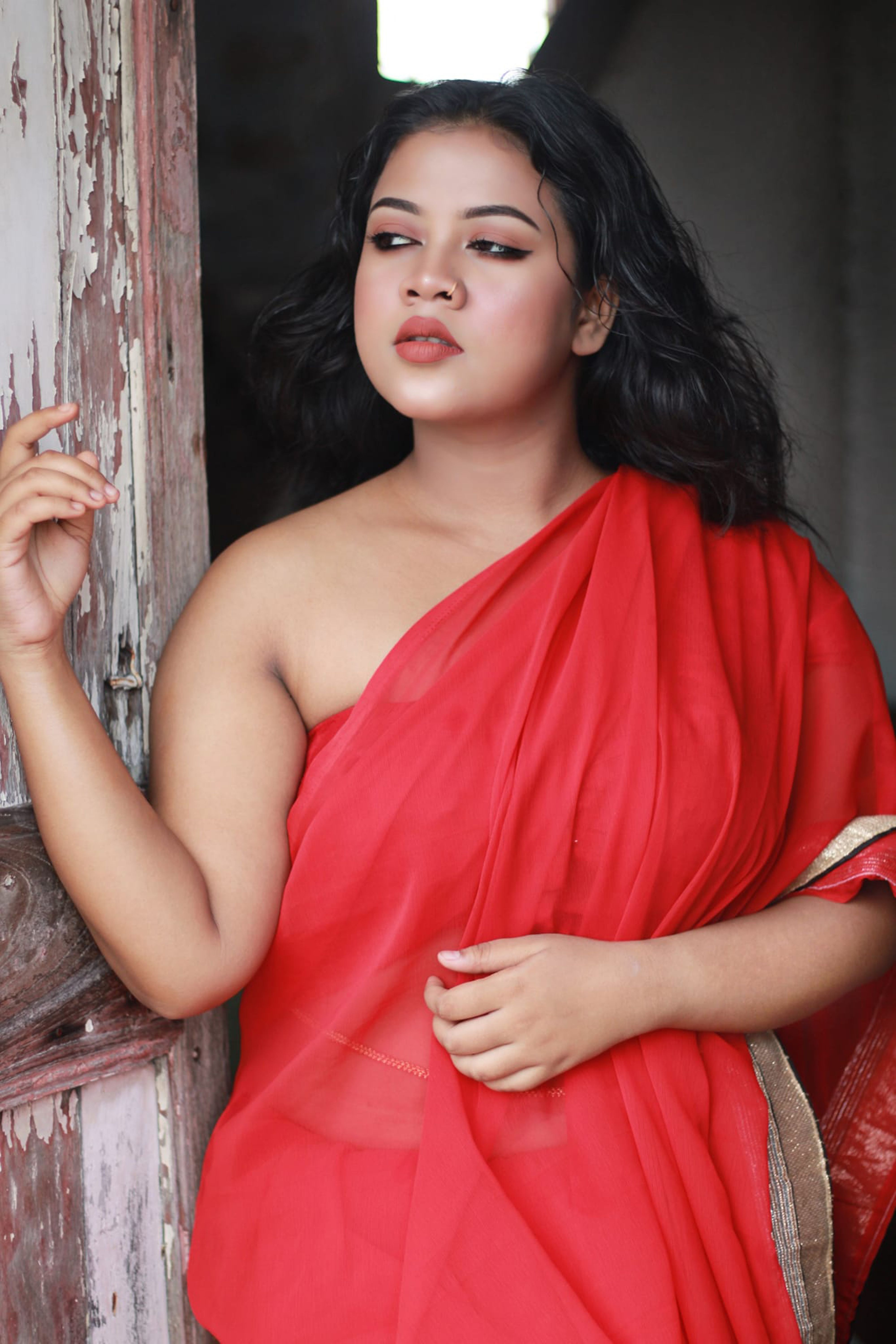 Portrait of an elegant woman in a vibrant red dress, exuding confidence and style.