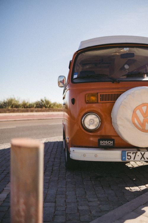 Free A classic yellow Volkswagen van parked by the road in sunny Cascais, Portugal. Stock Photo