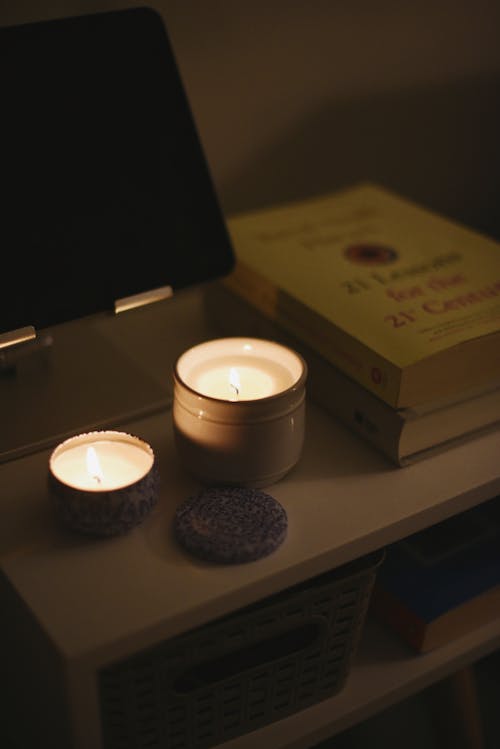 A candle and a book on a nightstand