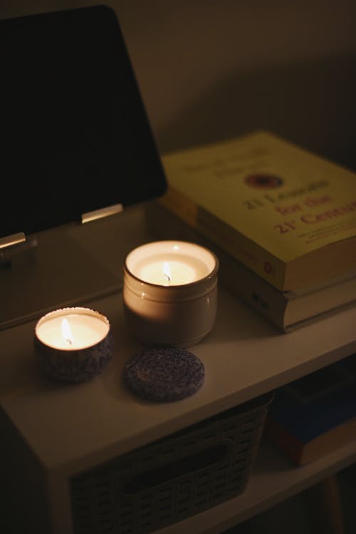 Wax Candles Burning near Book