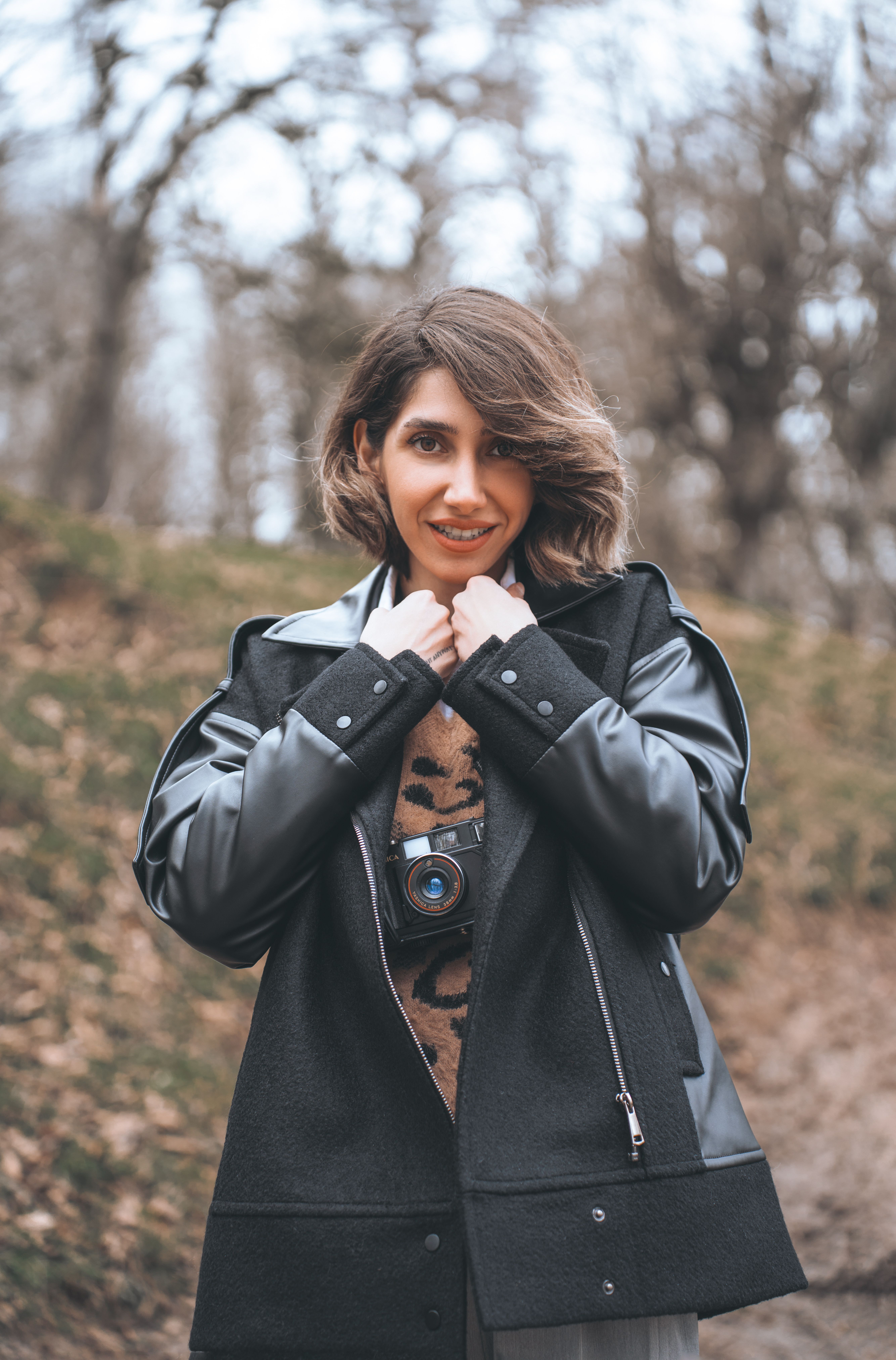 Woman in black leather jacket in fall