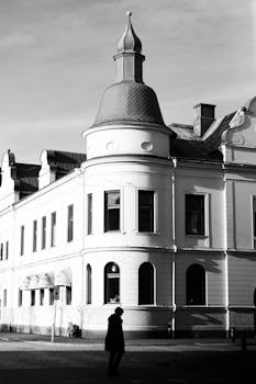 A striking black and white photo of a historical building in Jönköping, Sweden, with a silhouette of a person.