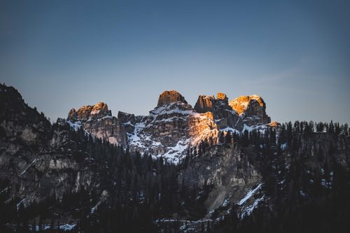 Free Stunning snowcapped rocky mountain landscape at sunrise with dramatic lighting. Stock Photo