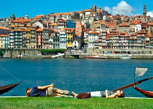 Woman and Man Lying Down by River in Porto