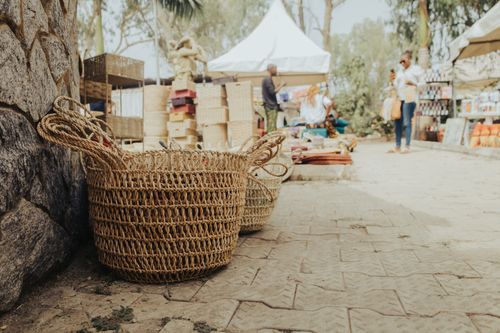Free Rustic handmade baskets displayed at a vibrant street market in Abuja, Nigeria. Stock Photo