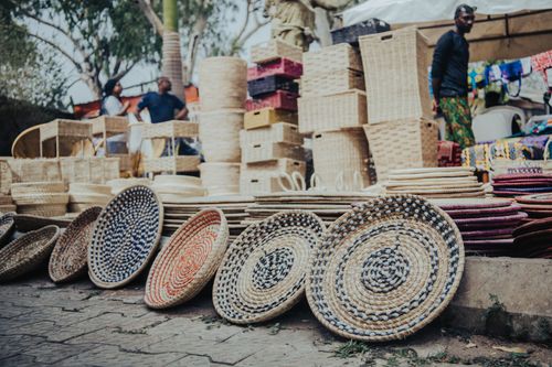 Free Colorful woven baskets displayed at an outdoor market in Abuja, Nigeria. Stock Photo