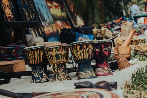 Free Vibrant traditional drums and crafts at an outdoor market in Abuja, Nigeria. Stock Photo