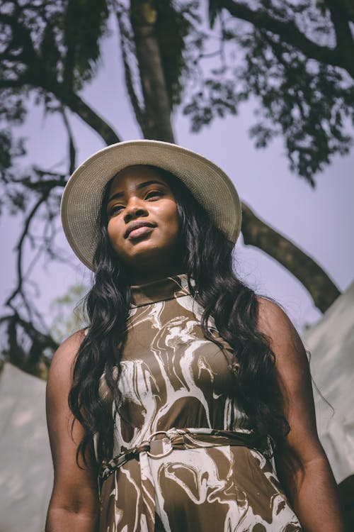 Portrait of a Long-Haired Model Wearing a Dress and a Fedora