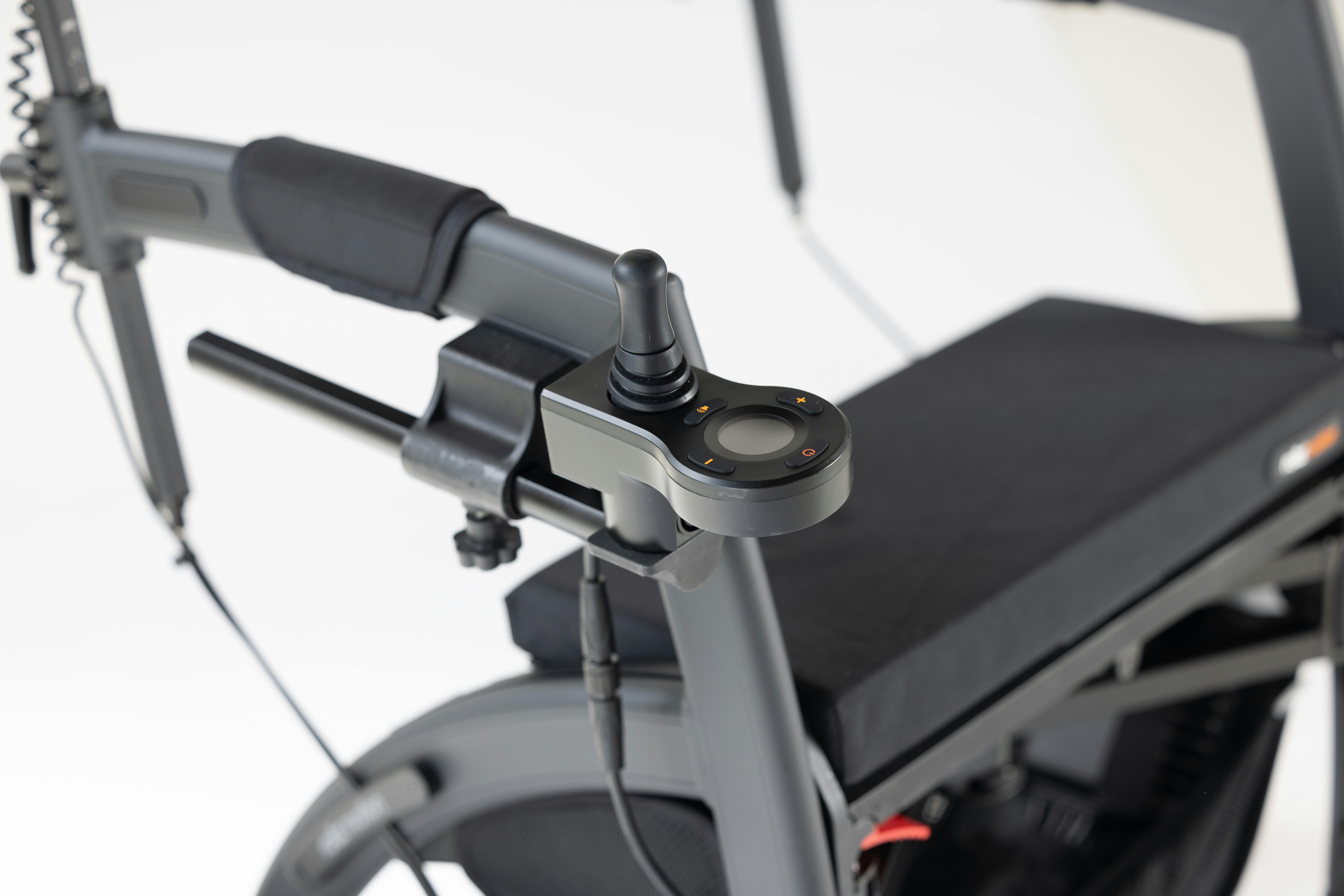 Close-up of a sleek, modern motorized wheelchair featuring advanced joystick controls on a white background.