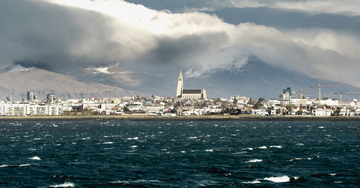 A stunning view of Reykjavík's skyline featuring the iconic Hallgrímskirkja church and ocean in Iceland.