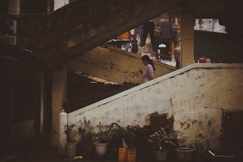 Woman Walking on Concrete Stairs