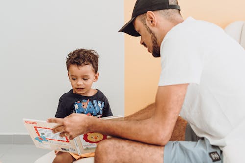 Free Boy and Father with Book Stock Photo