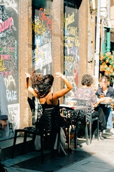 Candid street scene at a cozy café in Rennes, Bretagne, with people enjoying a sunny day.