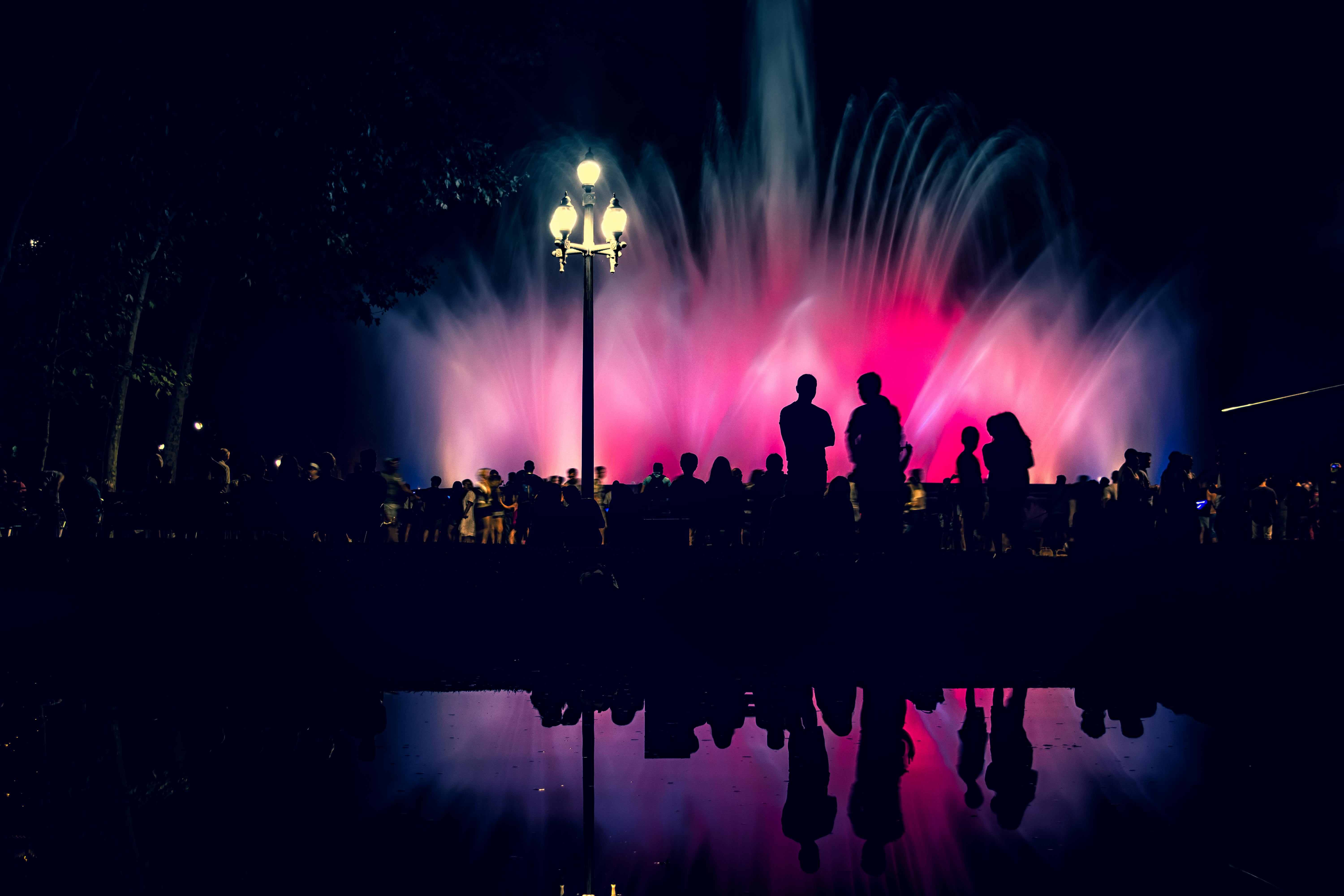silhouette of people near fountain