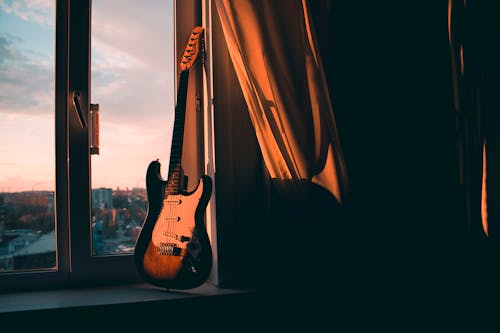 Free Guitar Beside Window Stock Photo