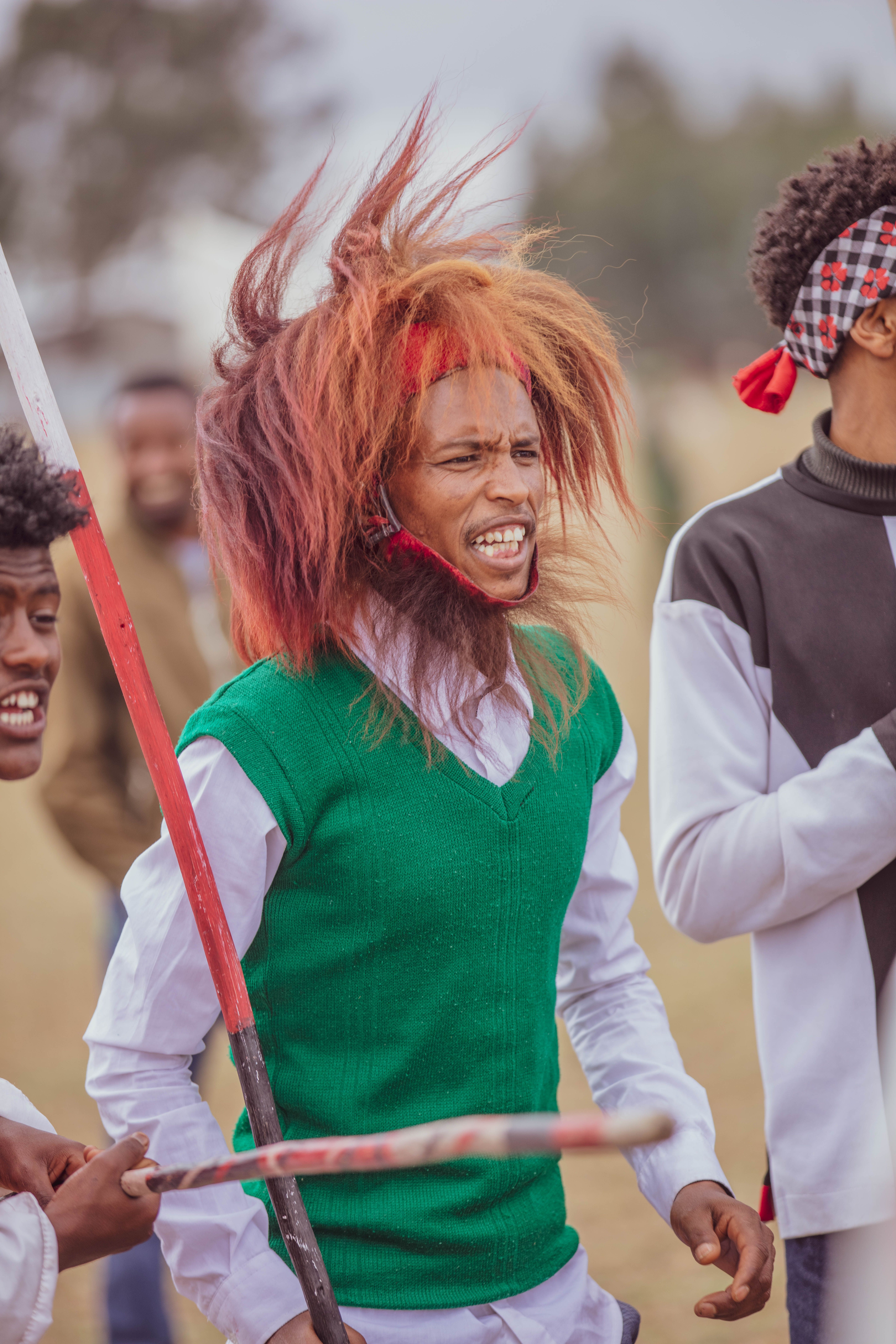 Vibrant outdoor cultural festival with traditional attire and joyful participants.