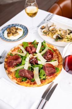 Delicious gourmet pizza with wine in a stylish Istanbul restaurant setting.