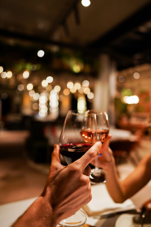 Couple is Clinking with Wineglasses