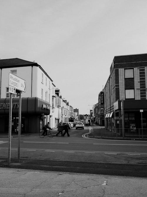 Black and white photo of a street with people walking
