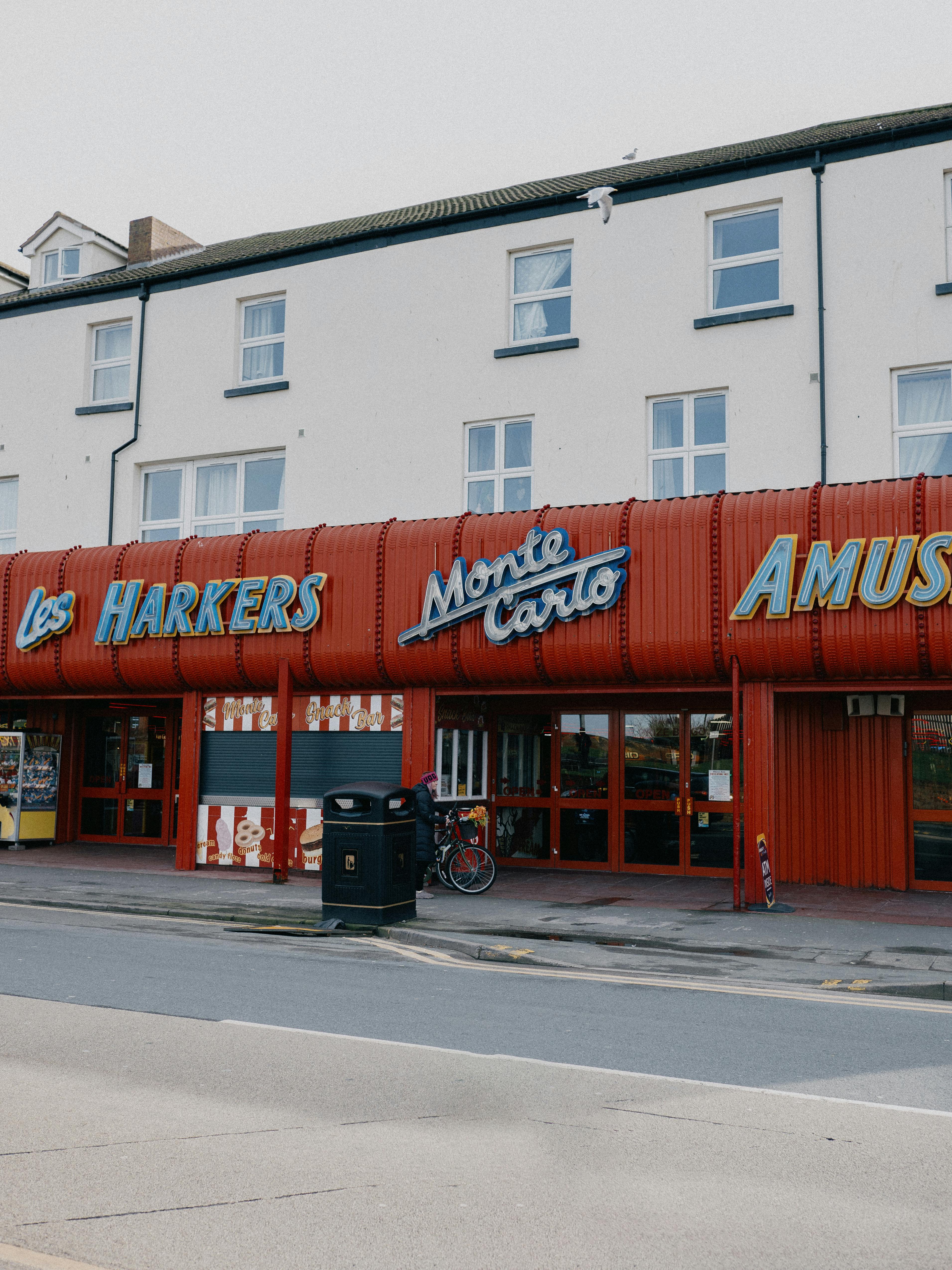 Vintage arcade facade with bold signage in a Welsh town, capturing urban charm.