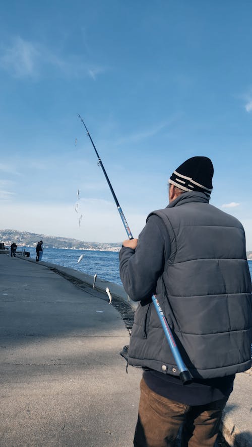 A man is fishing on the beach