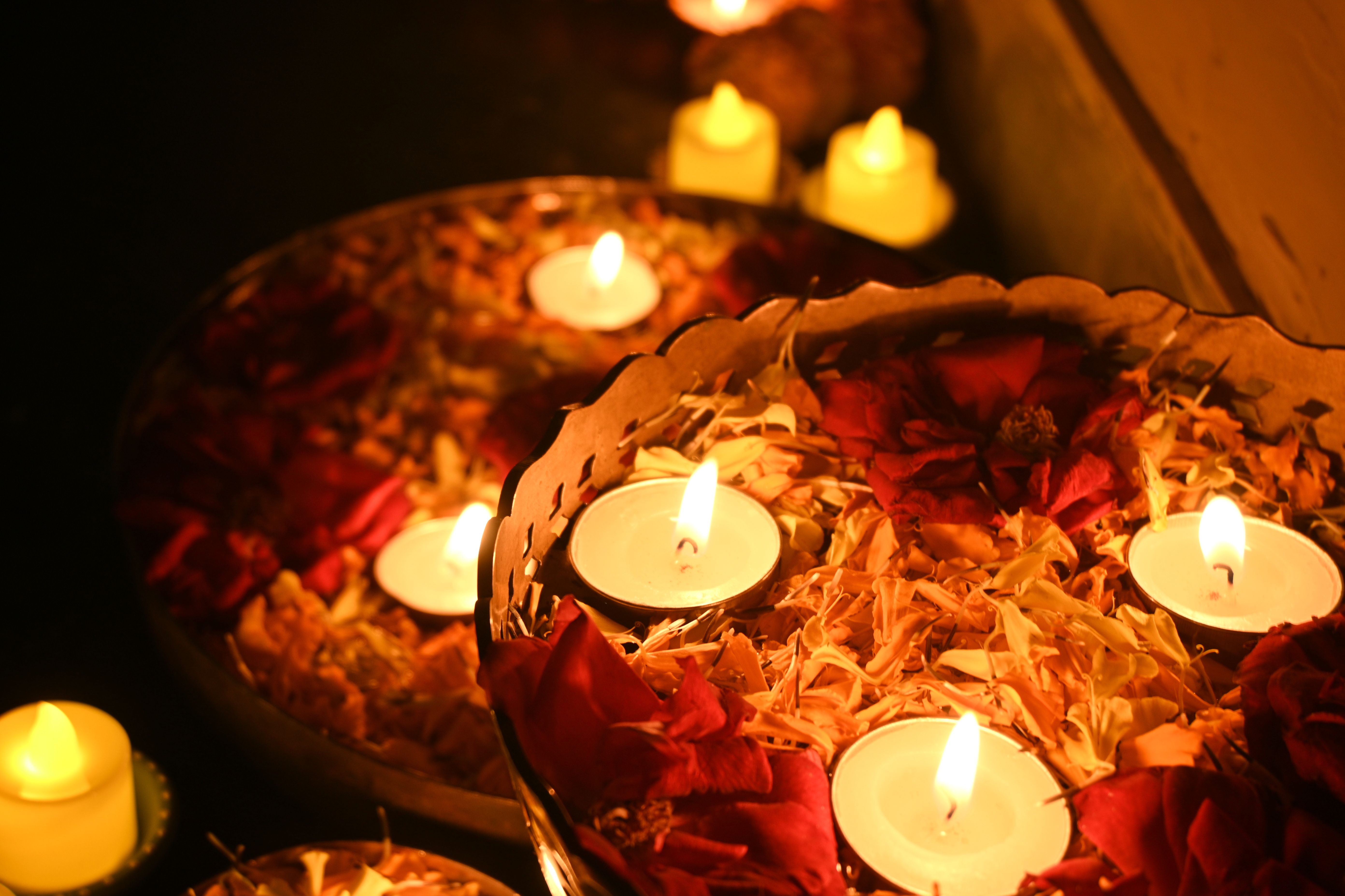 Tea Candles Floating on Water Among Flower Petals · Free Stock Photo