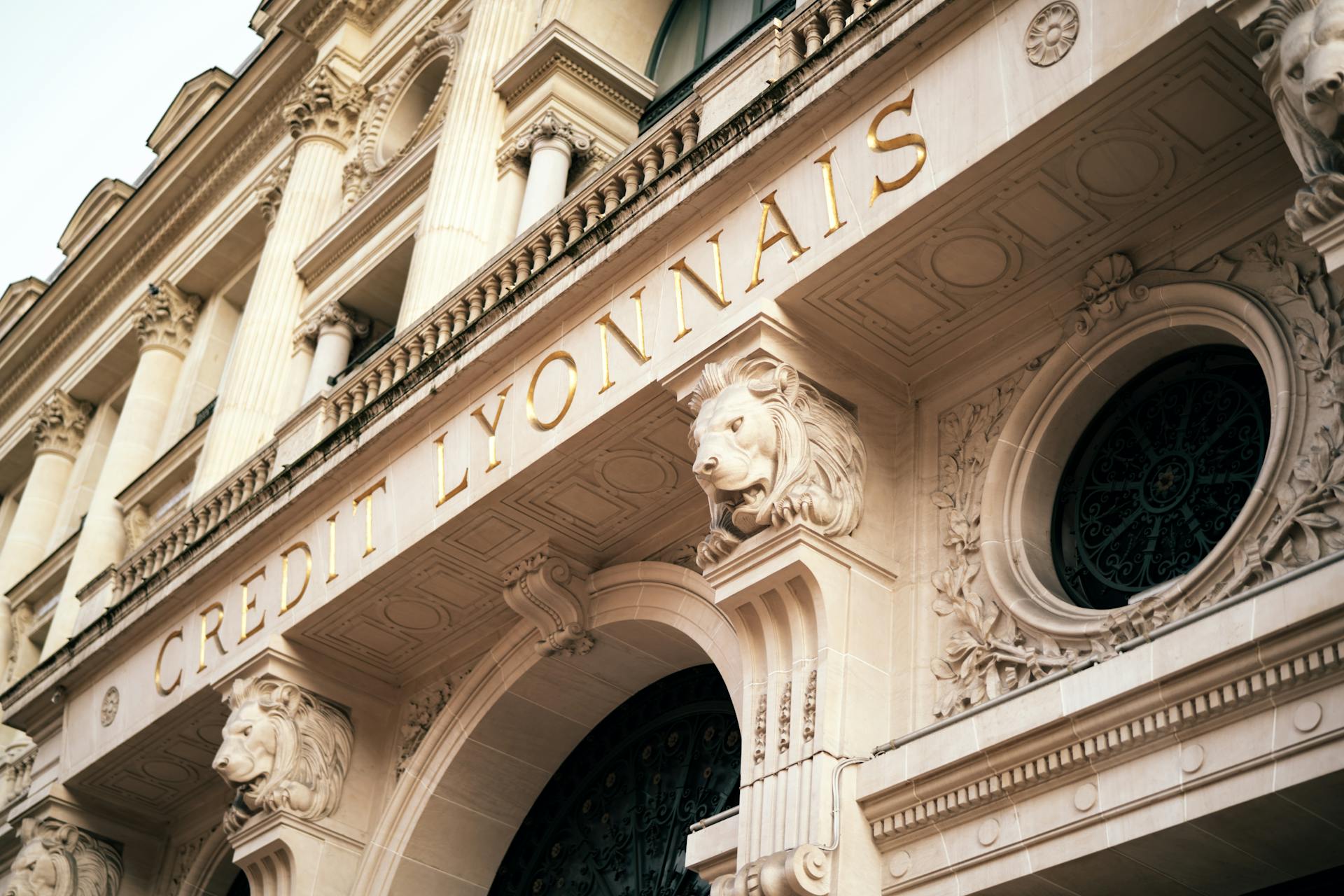 Elegant facade of Credit Lyonnais in Paris showcasing detailed architectural sculpture and ornate carvings.