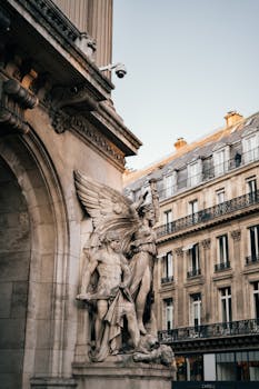 Detailed view of sculptures at Palais Garnier, capturing Parisian architecture and art.