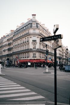 Charming Parisian street scene featuring historic architecture and vibrant city life near Palais Garnier.