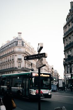 Paris street scene featuring a bus, historic architecture, and city ambiance.