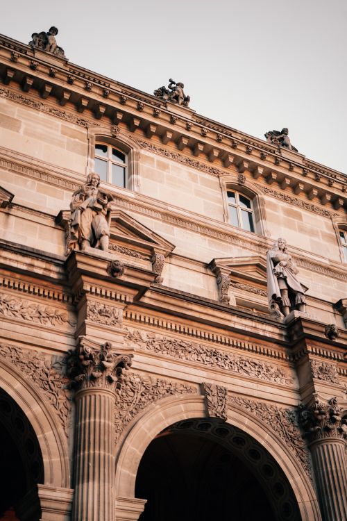 Free Explore the detailed architecture of Paris with ornate carvings and sculptures on a historic facade. Stock Photo
