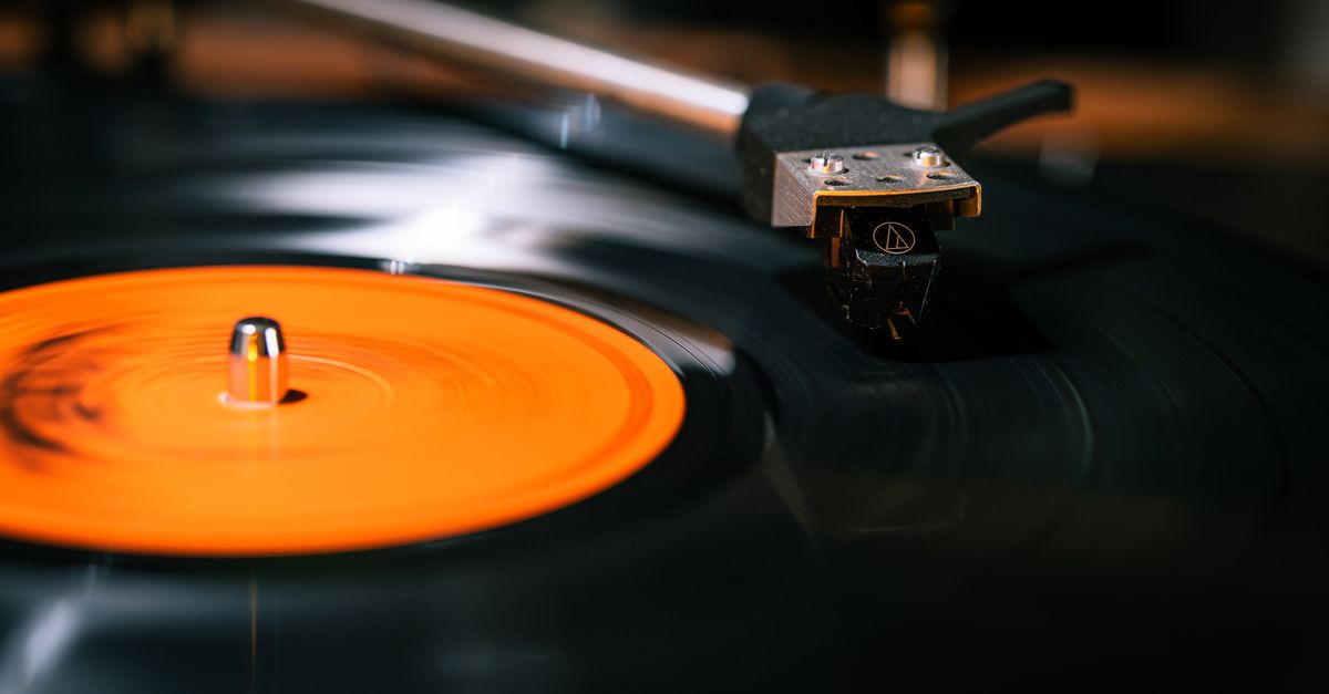 vinyl record spinning on a turntable with warm lighting