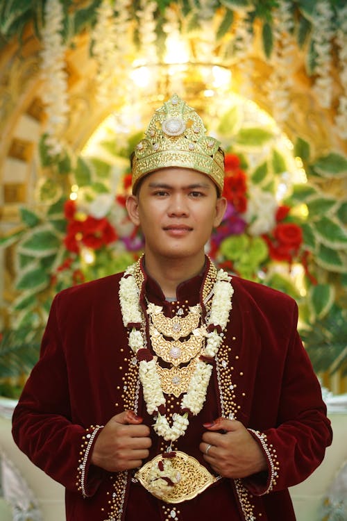 A man in traditional attire posing for a photo
