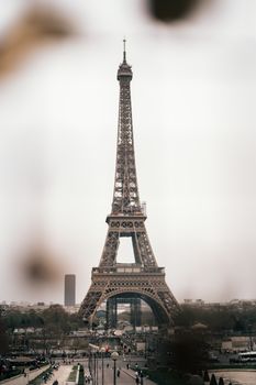View of the iconic Eiffel Tower in Paris captured on a cloudy day, showcasing historic architecture.