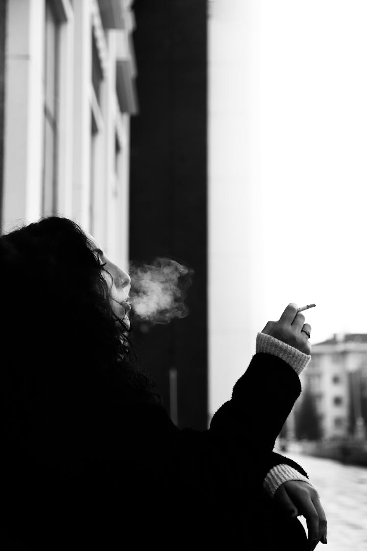 Woman Smoking Cigarette On Street