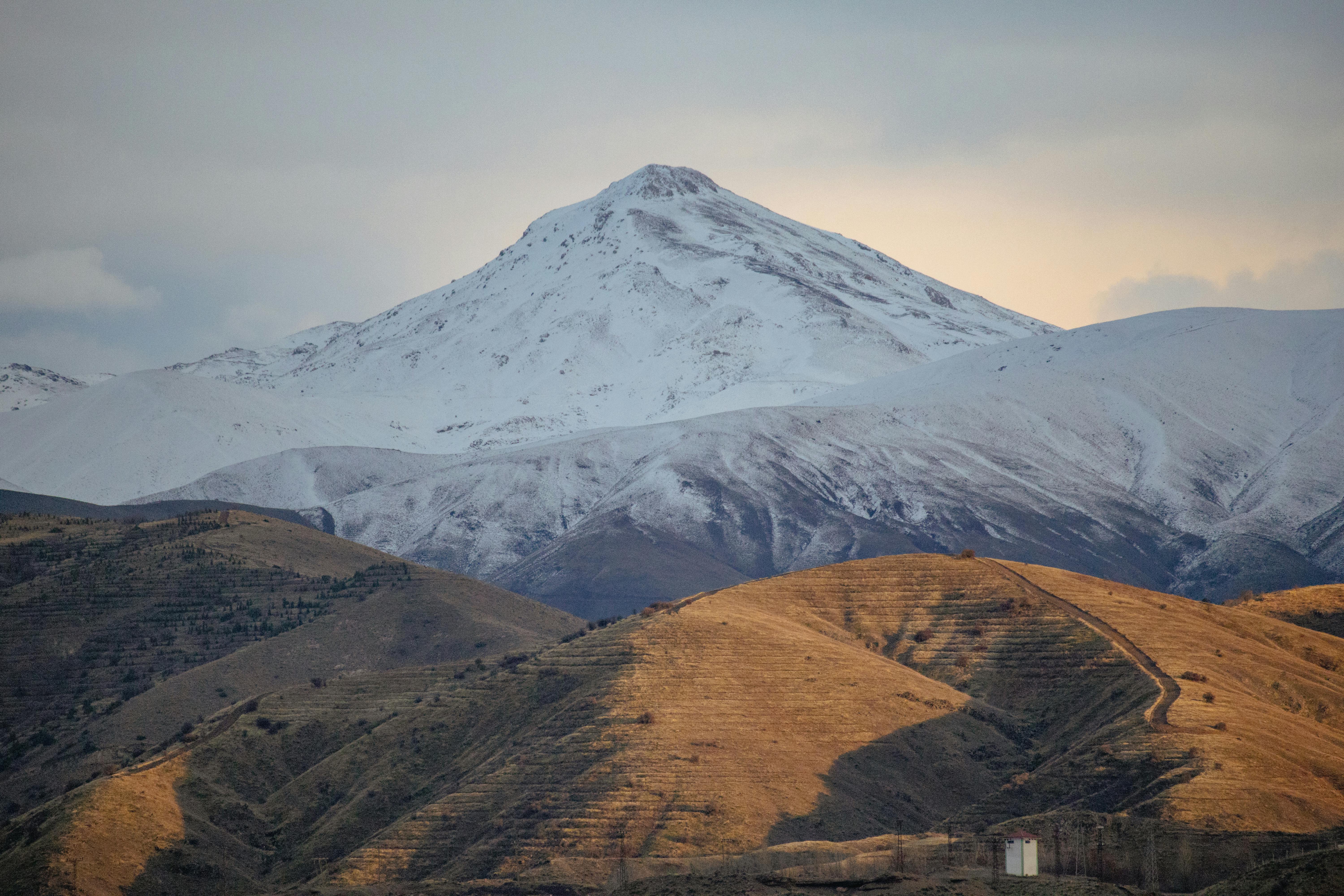 hills and a snowcapped mountain in iran