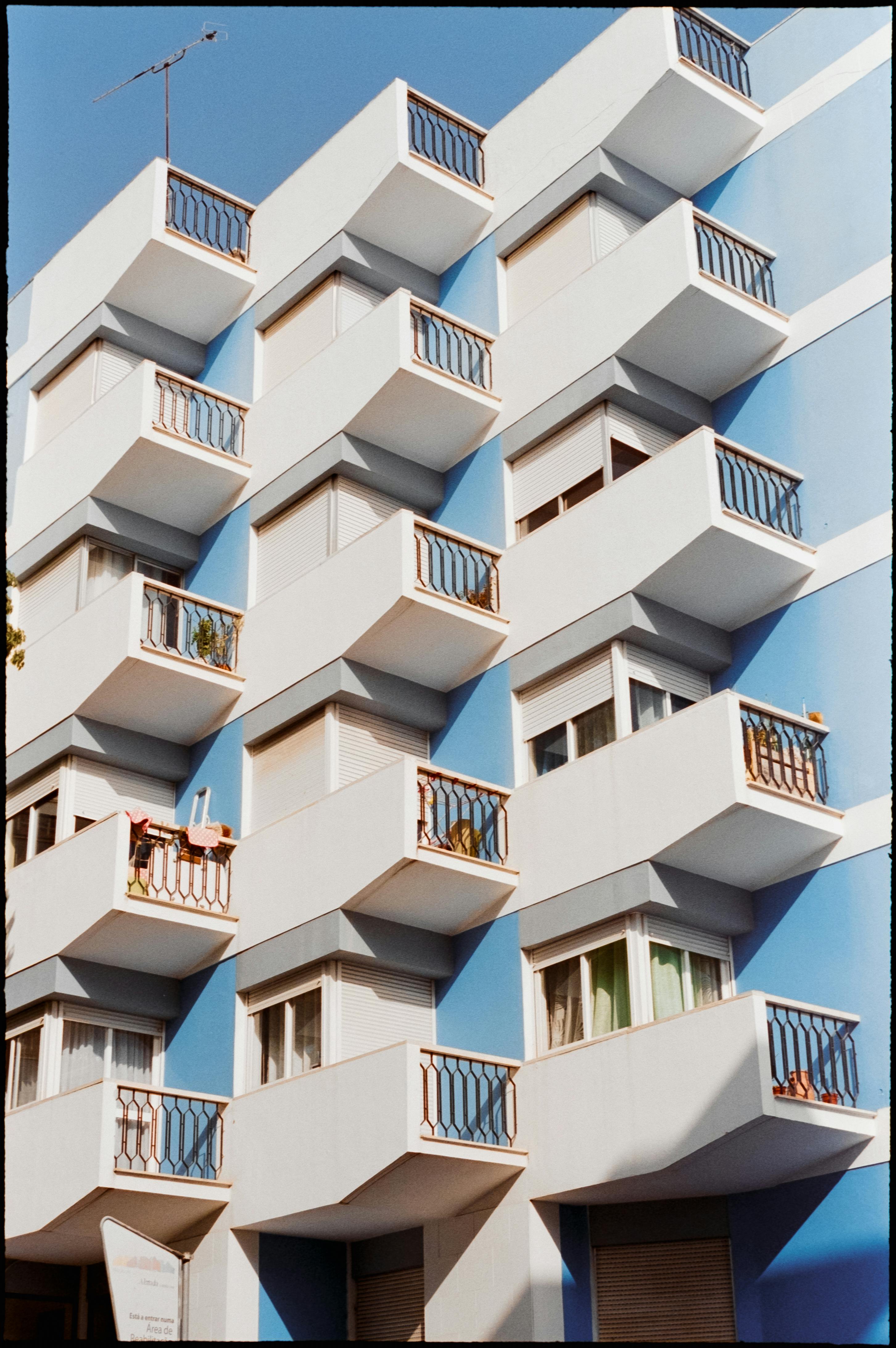 Modern architecture of a blue building in Lisbon with striking geometric balconies.