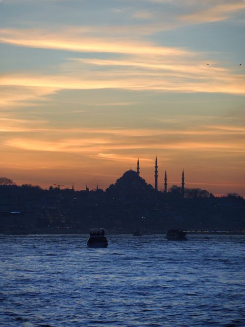 Free Scenic view of Istanbul's skyline featuring a mosque silhouette against a vibrant sunset over the river. Stock Photo