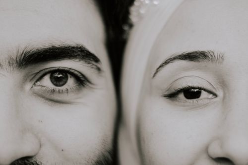 Free Intimate black and white close-up of a couple's eyes creating a symmetrical composition. Stock Photo