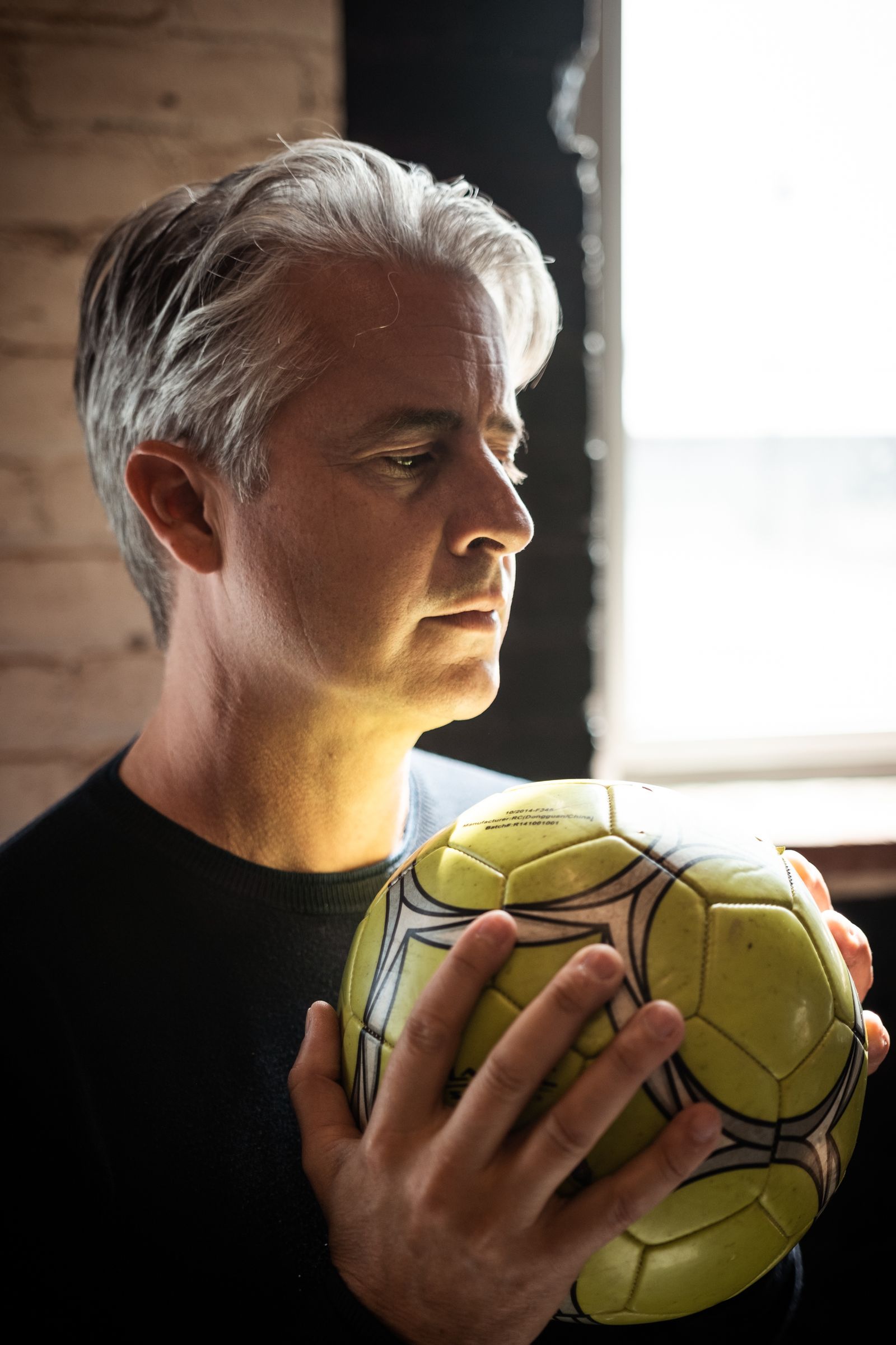 Portrait of coach holding a match ball