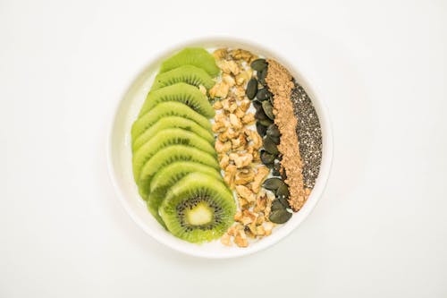 A Smoothie Bowl with Fruit and Nuts on Top 