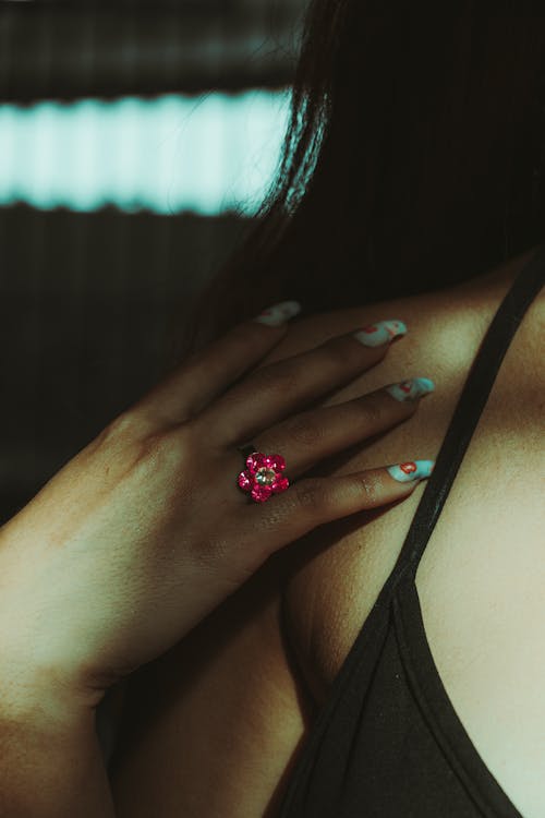 A woman with a pink ring on her finger